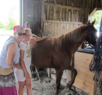 justine standing with a horse