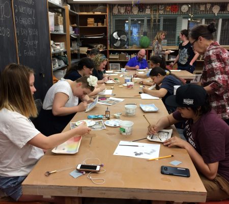 youth painting ceramic plates